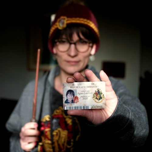 Agnes holding her Hogwarts Student ID